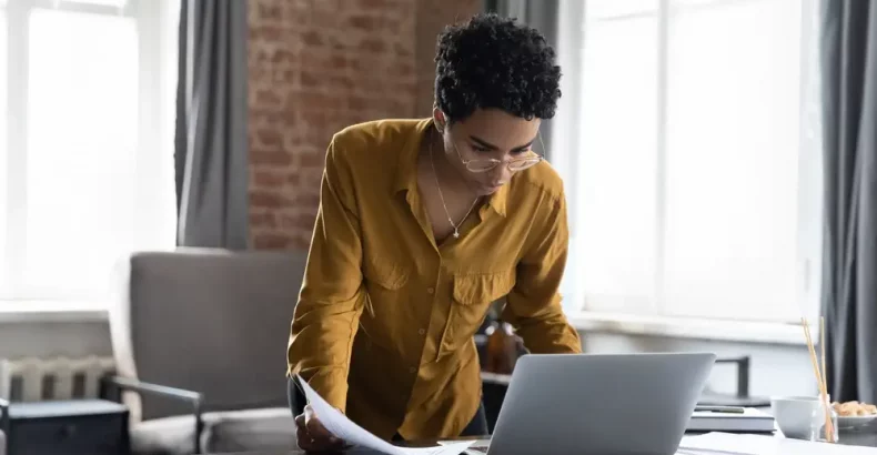 Women looking at a laptop standing up