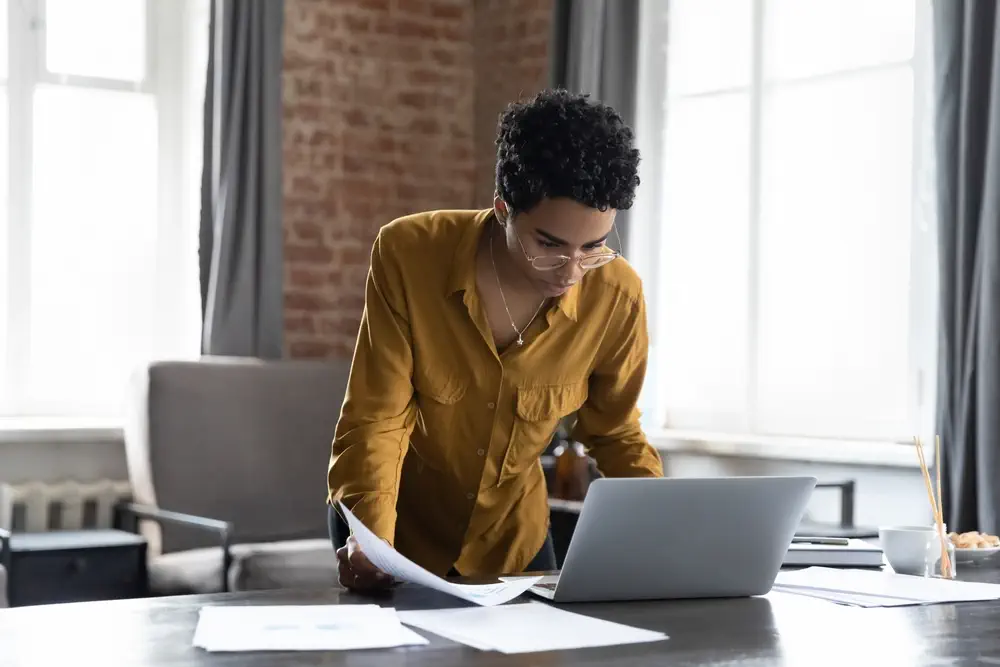 Women looking at a laptop standing up