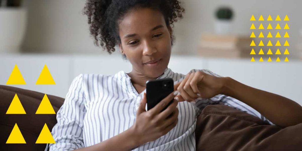 Woman looking at phone on a sofa