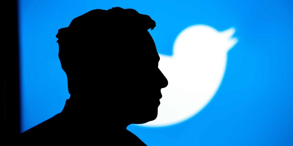 Elon Musk Silhouette in front of Twitter Logo 