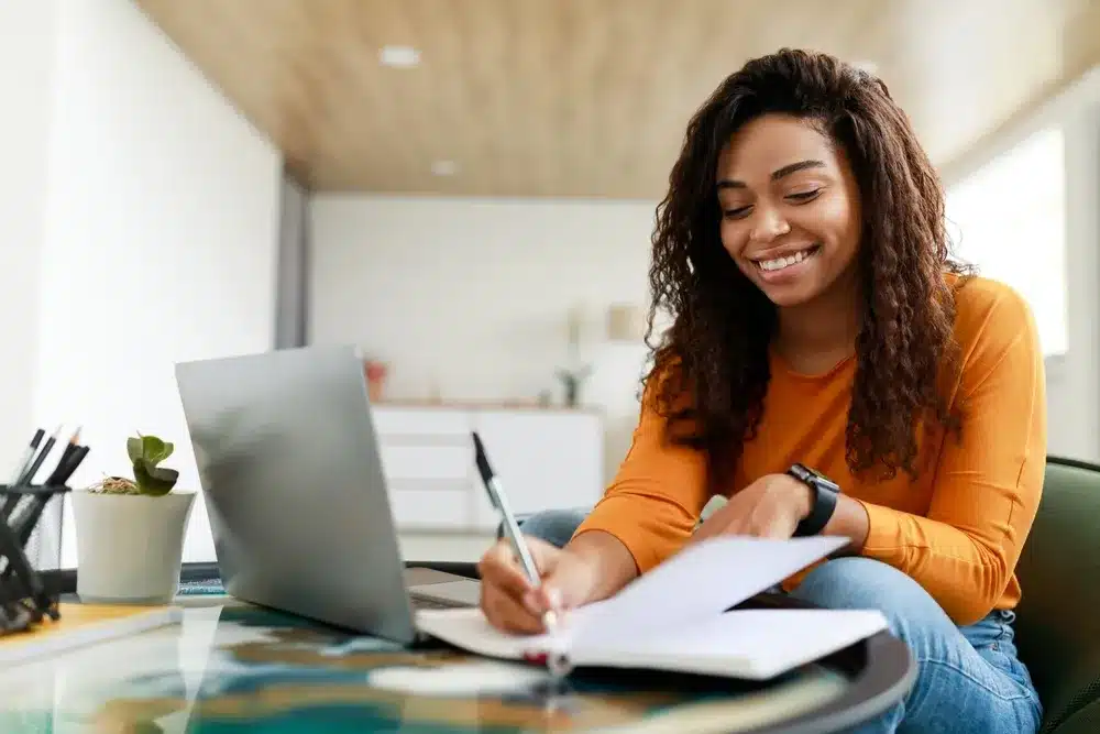 Young woman looking at a laptop studying SEO