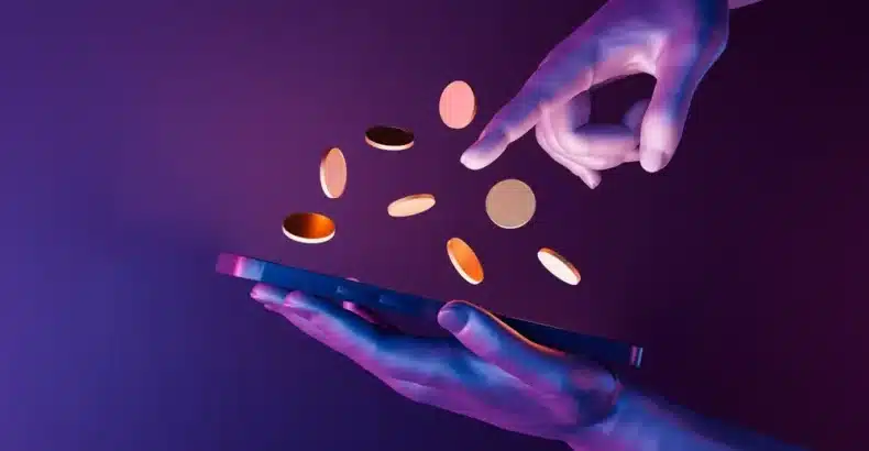 Hands holding a phone with coins inbetween