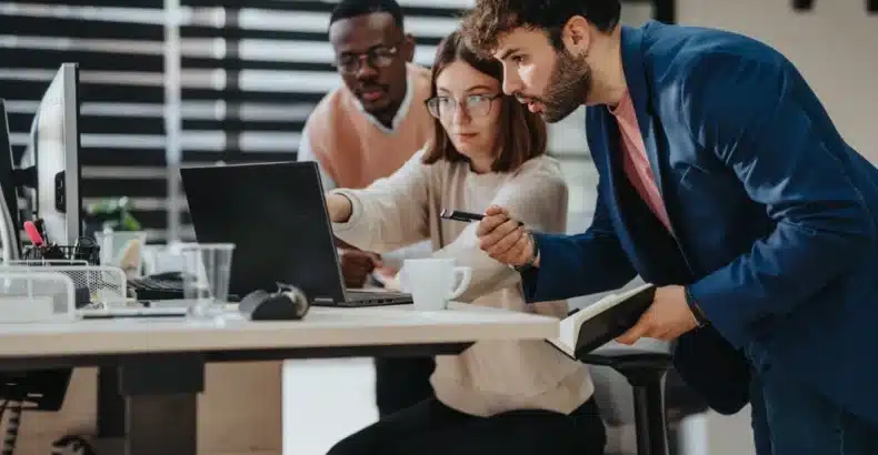 Group of young people looking at a computer