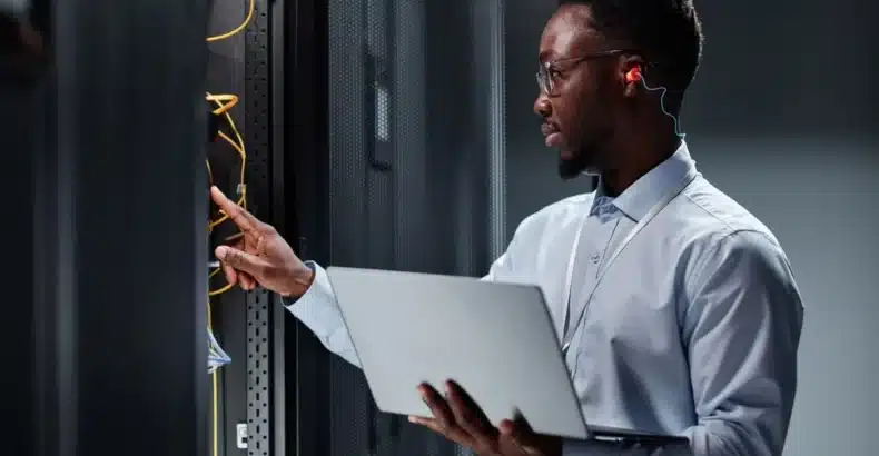 Computer technician holding a laptop