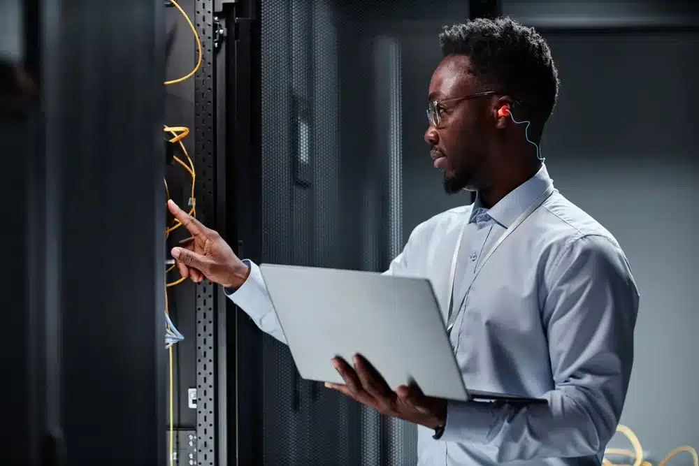 Computer technician holding a laptop